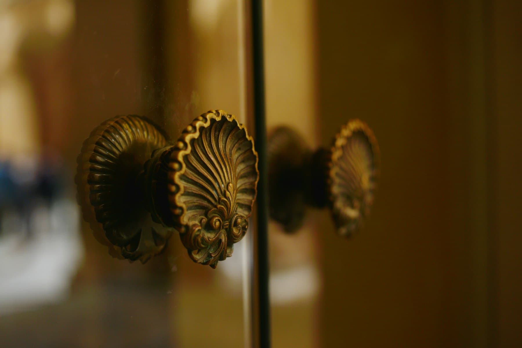 Close-up of ornate brass door handles