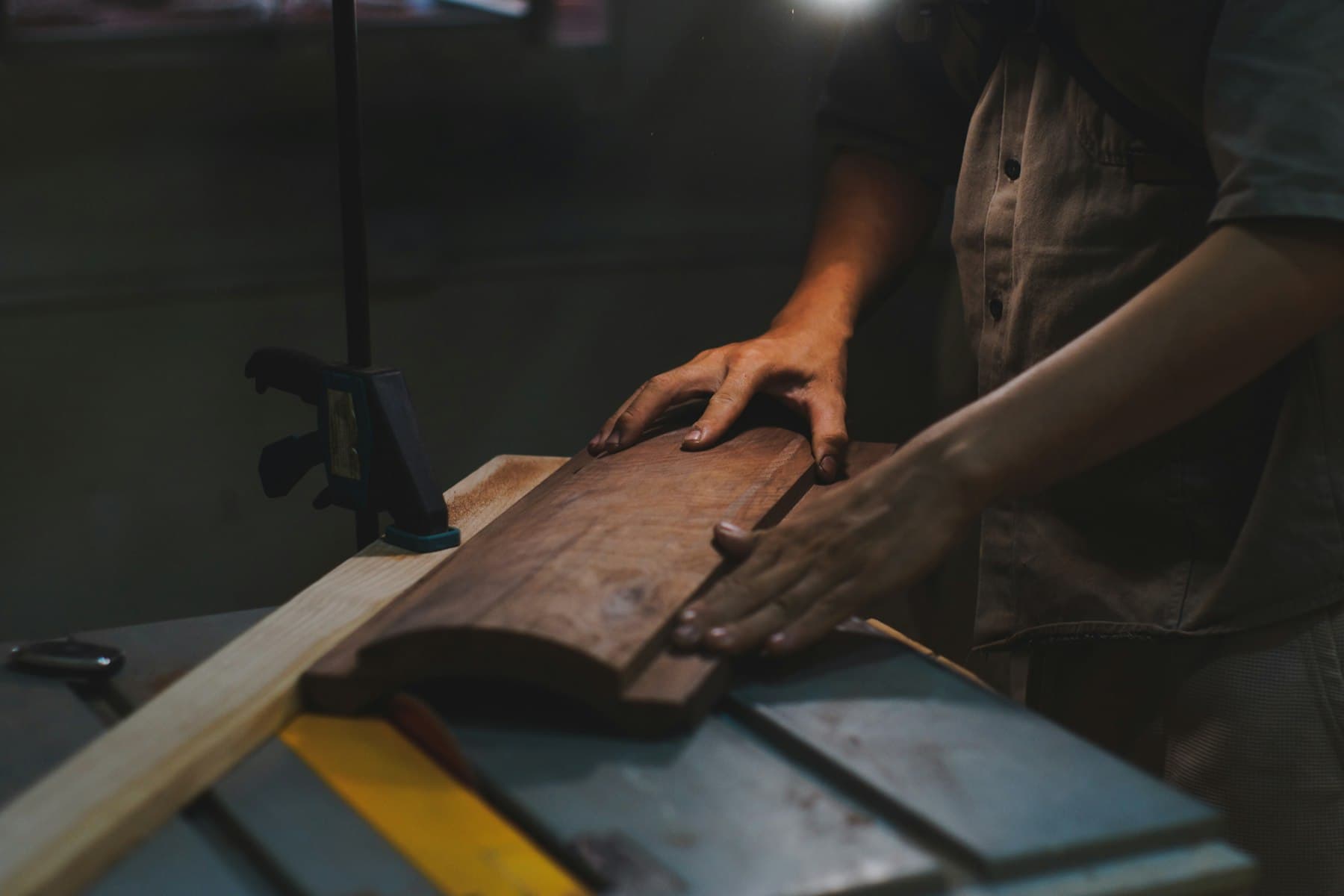 Craftsman finishing a hardwood furniture component