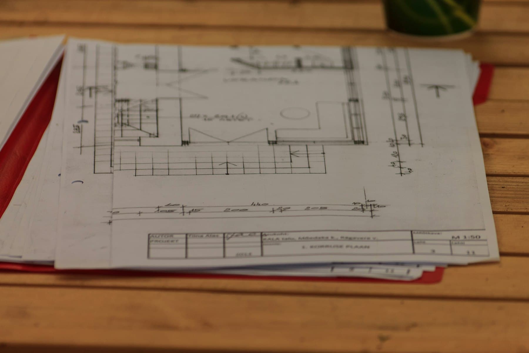 Hand sketching initial ideas over printed drawings