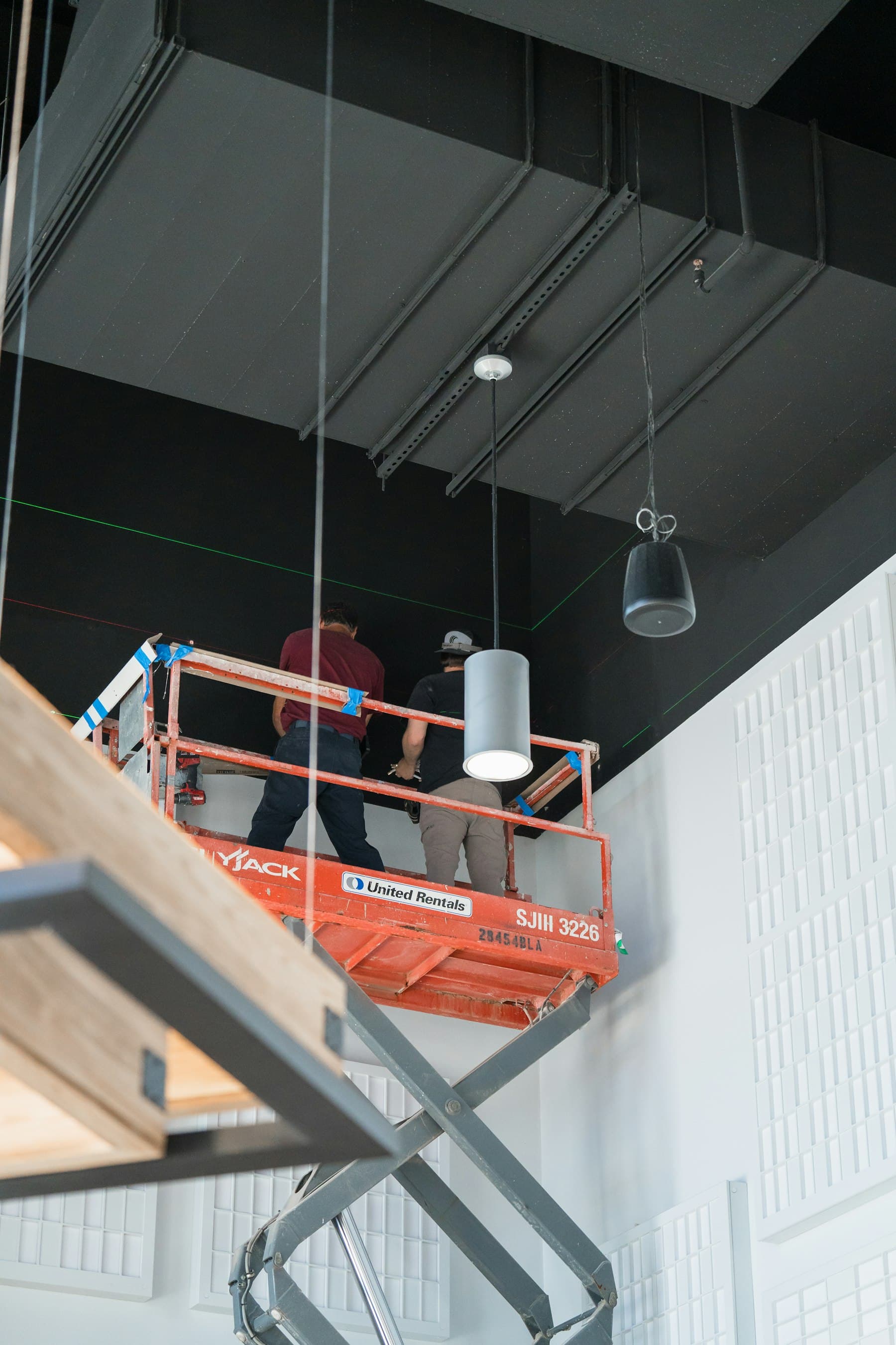 Site team installing services from a scissor lift