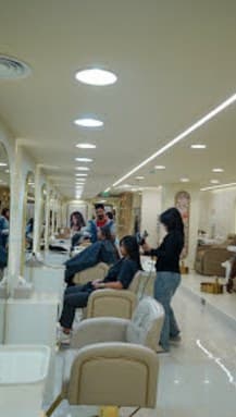 Styling floor with mirrored stations and cream salon chairs