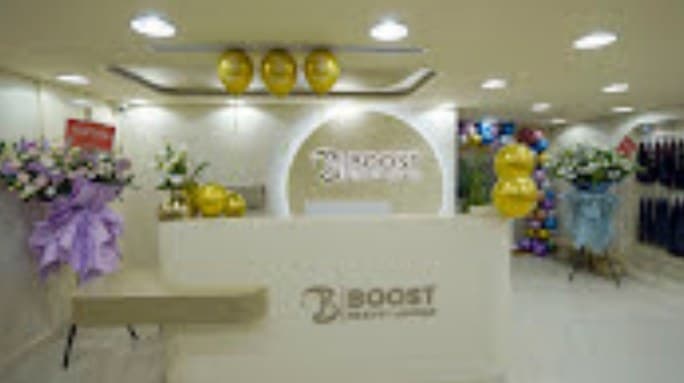 Beauty lounge reception with branded arch and white counter