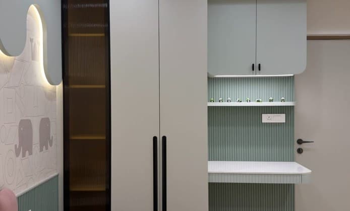 Children's room with sage wardrobes, study desk and backlit wall feature