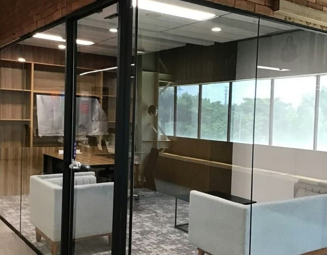 Executive cabins behind full-height glass partitions
