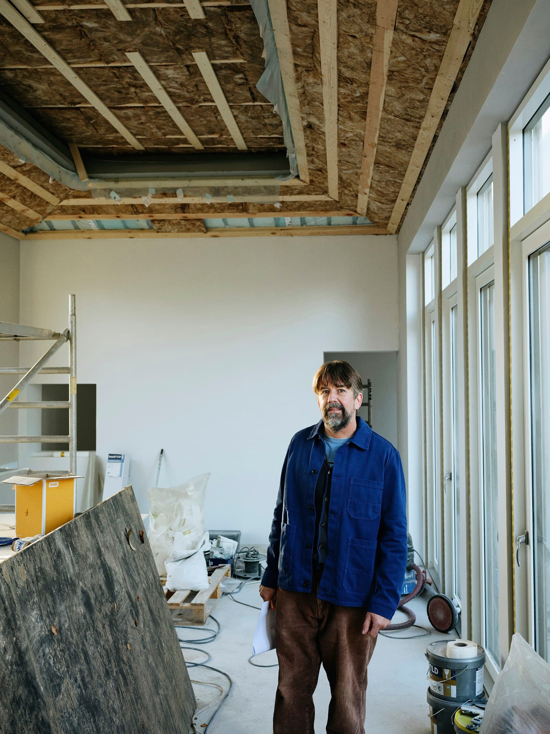 Project lead reviewing progress inside an interior under construction