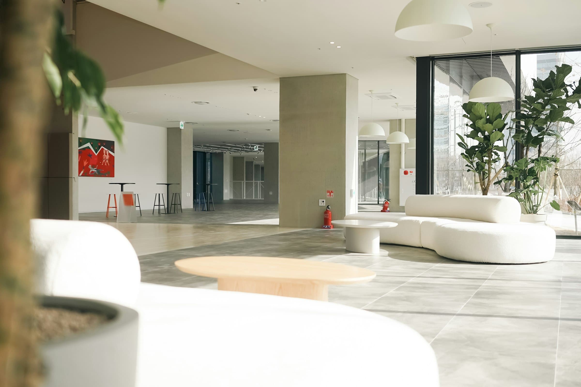 Bright contemporary lobby with curved white seating and full-height glazing